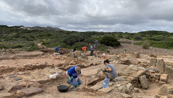 People on an archaeological site in Menorca.
