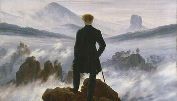 Wanderer above the Sea of Fog painting. Man stands alone on rocks looking at misty ocean. 