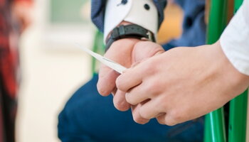 students passing paper