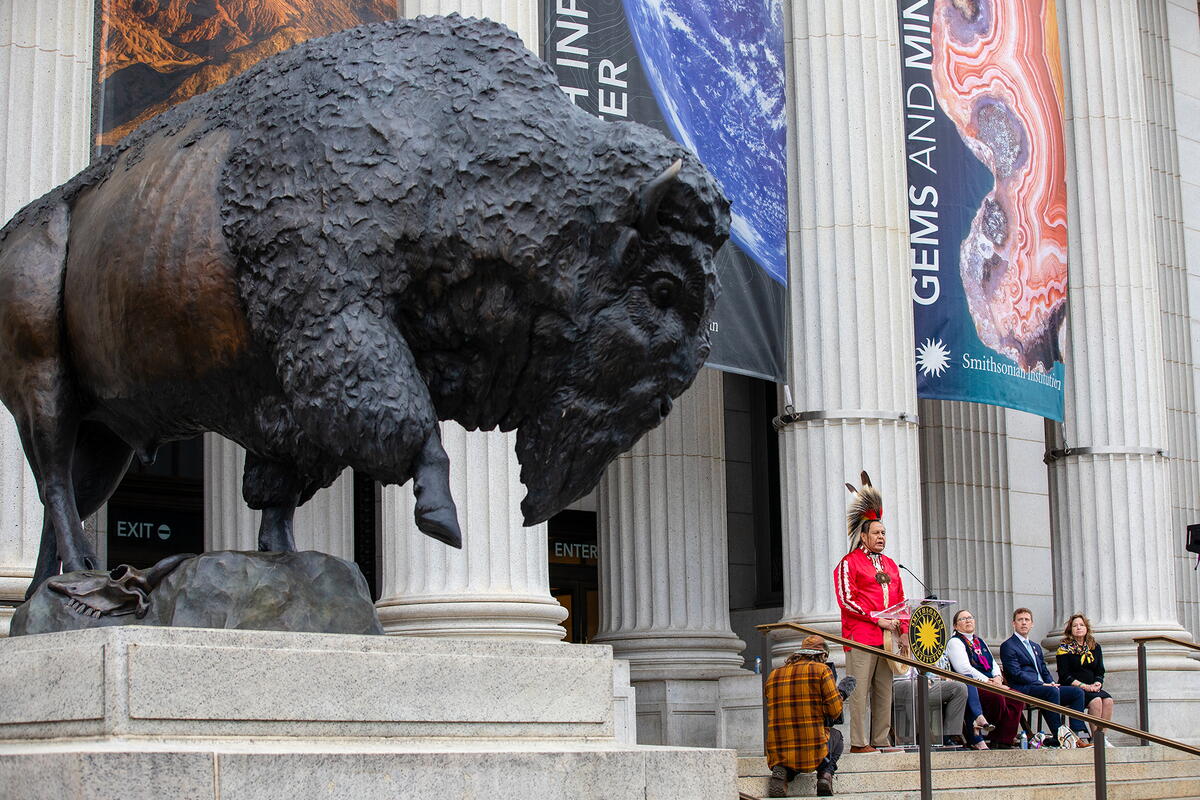 Organizers and honorees stand outside the new Natural History museum at the Bison unveiling ceremony.
