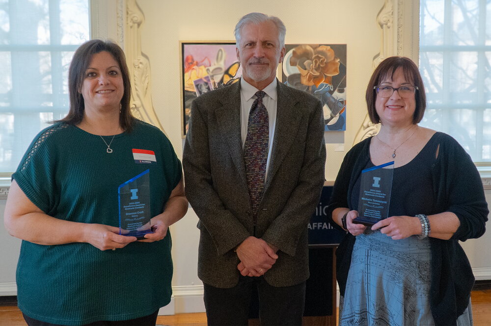 Shannon Croft and Michelle Tomaszycki pose with their awards with Dean Wojtek Chodzko-Zajko