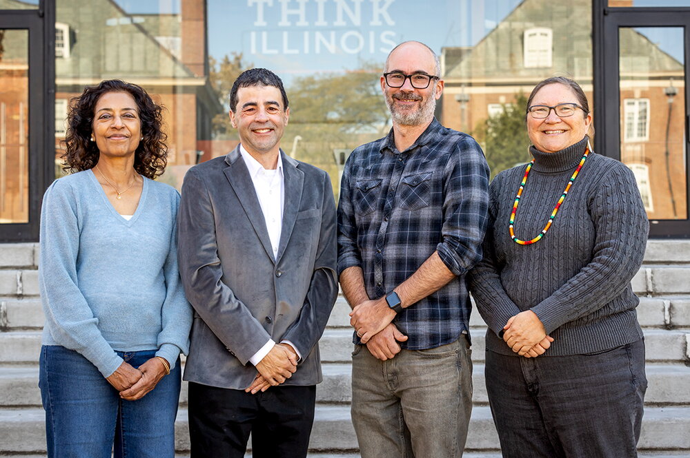 four faculty members who lead this project pose as a group on steps outside.