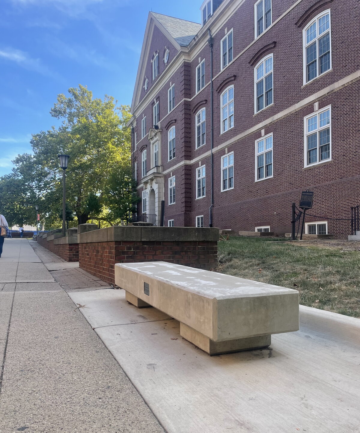 bench on the quadside of gregory hall on a sunny day