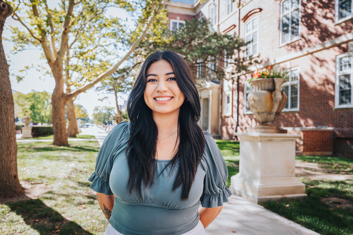 Young woman standing outside gregory hall.