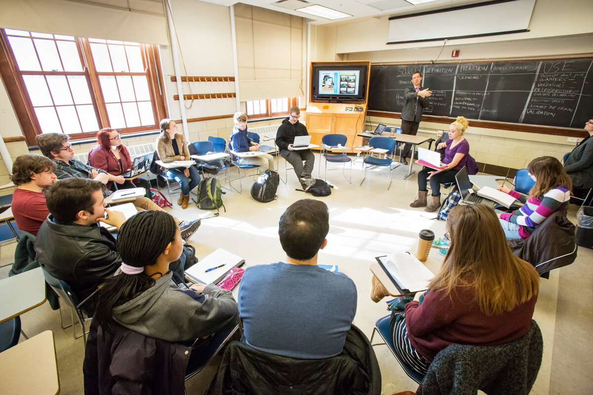 students in a circle in a classroom in gregory hall