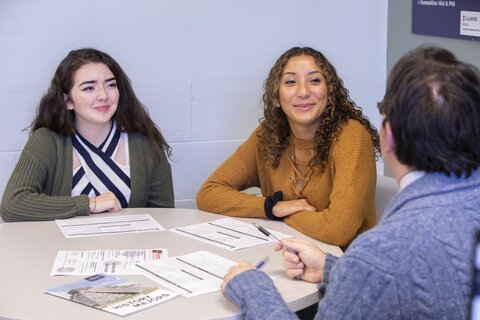 Two history undergraduates in an academic advising meeting, seated