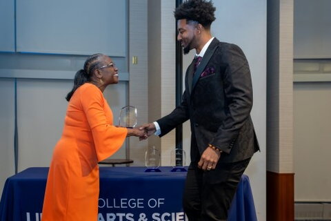 Crim accepts award from Dean Patton