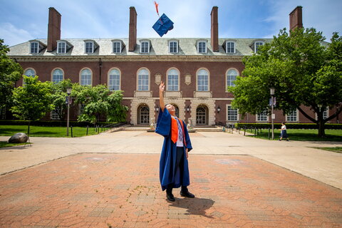 Student tossing graduation cap in the air