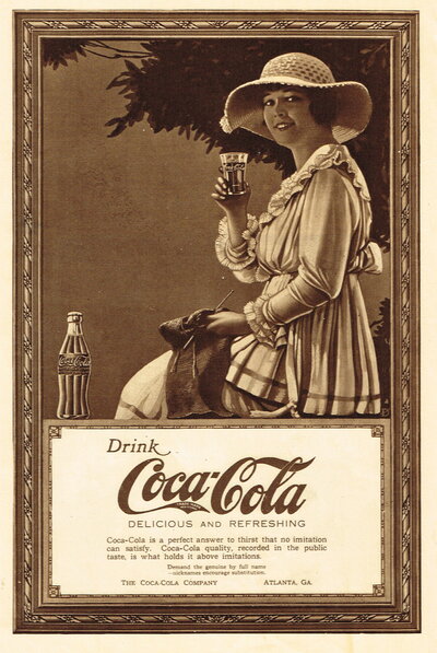 An old advertisement for Coca-Cola featuring the Coca-Cola Girl, who is smiling holding a glass of Coca-Cola.
