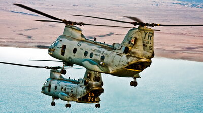 Two helicopters fly across the Al Anbar Province