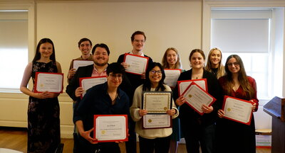 undergrad award recipients hold their award certificates