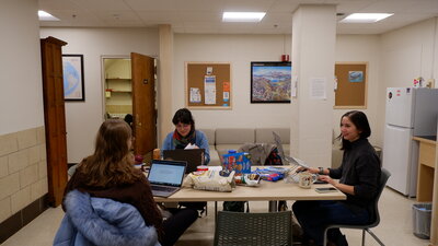 a group of people at a table in a lounge