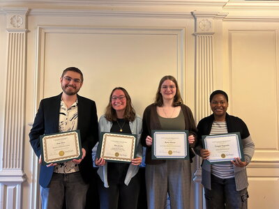 Graduate award recipients pose with award certificates
