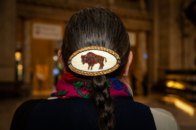 A close up on a beaded buffalo hair clip worn by LaPier.