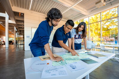 students and professor looking at documents