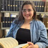 An image of Mary Schiavone holding a book.