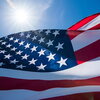 sun shining on american flag