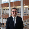 Noam Zipris standing in an atrium.