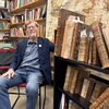 Ralph Mathisen poses with manuscripts from his own collection.