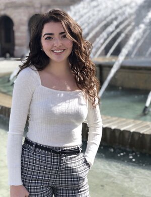 Carmen, next to a fountain in Pavia, IT