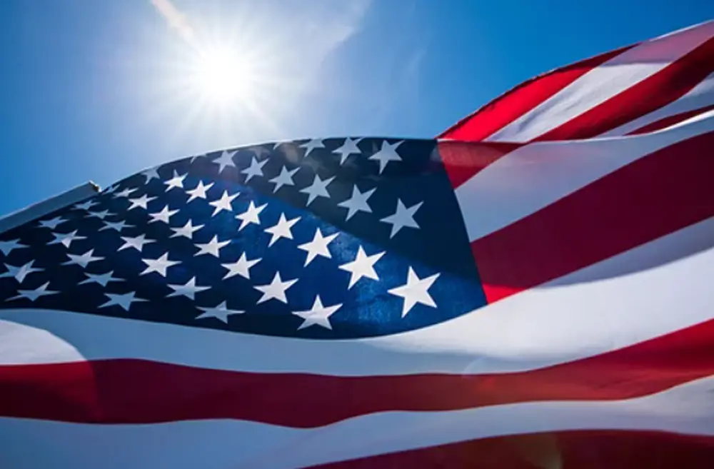sun shining on american flag