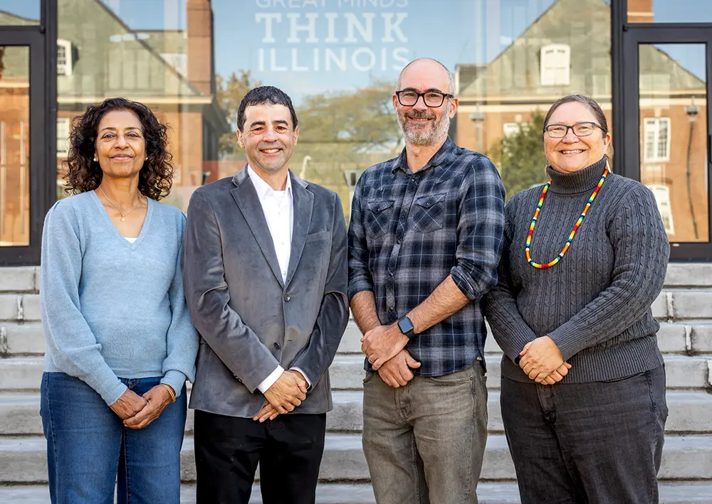 four faculty members who lead this project pose as a group on steps outside.