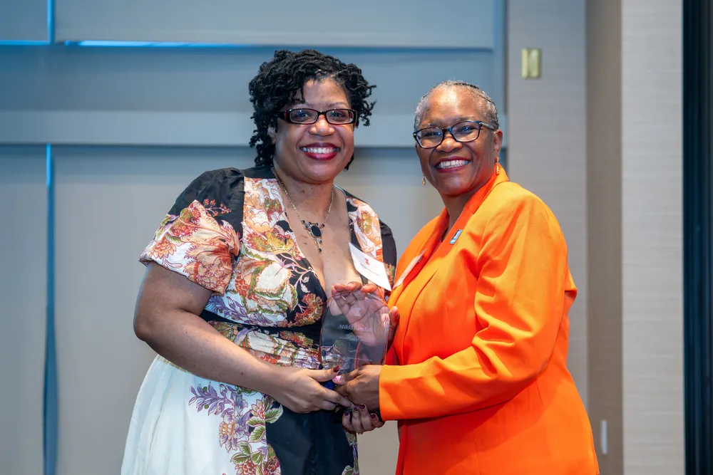 Mikki Kendall accepts an award from Dean Venetria Patton