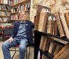 Ralph Mathisen poses with manuscripts from his own collection.