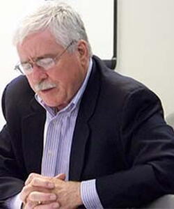 Charles C. Stewart clasping his hands.