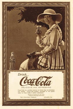 An old advertisement for Coca-Cola featuring the Coca-Cola Girl, who is smiling holding a glass of Coca-Cola.