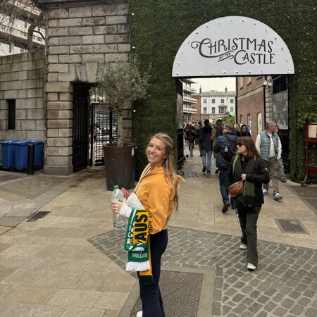 Image of Hailey in front of the Christmas Castle entrance 