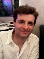 An image of Anthony smiling in front of tables at a restaurant.