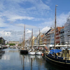 An image of houses next to a waterway with boats in Copenhagen.